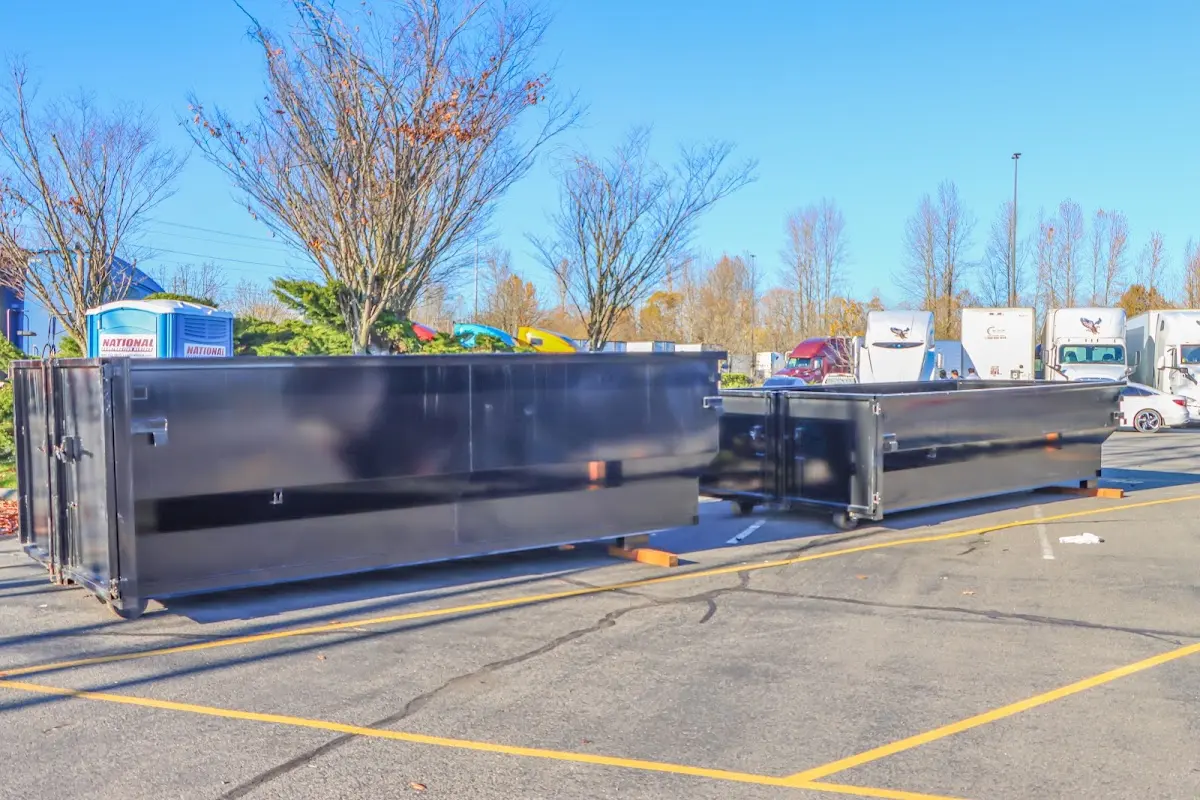 Professional dumpster rental service with roll-off container on residential driveway in West Lampeter